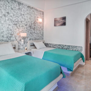 Twin Room II This is a cozy room with two seperated built in single beds and access to a private balcony. Suitable for non-couple guests. Bedroom area